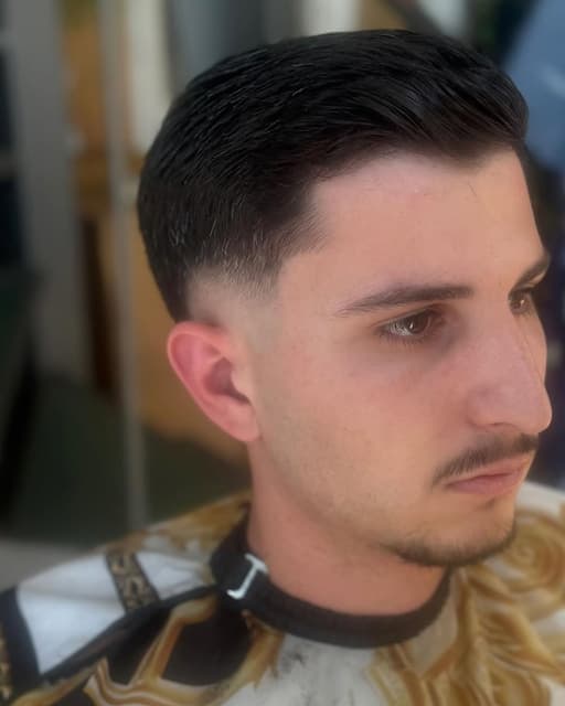Ανδρικό κούρεμα με καθαρό fade στα πλαϊνά και όγκο στην κορυφή